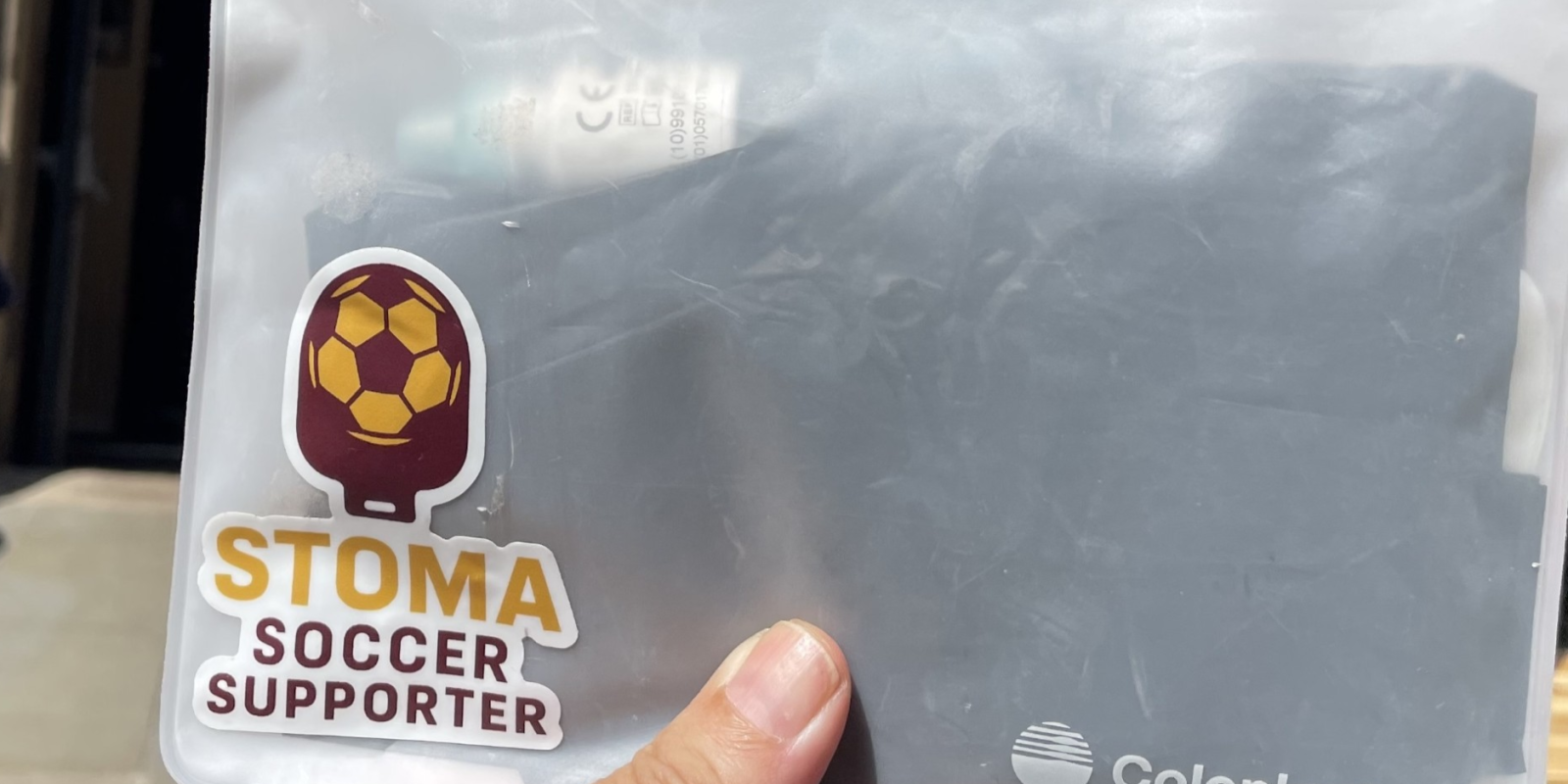 Hand holding an emergency stoma pack