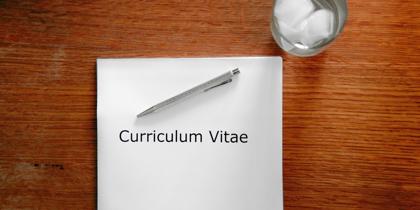 CV lies on a desk with the words Curriculum Vitae
