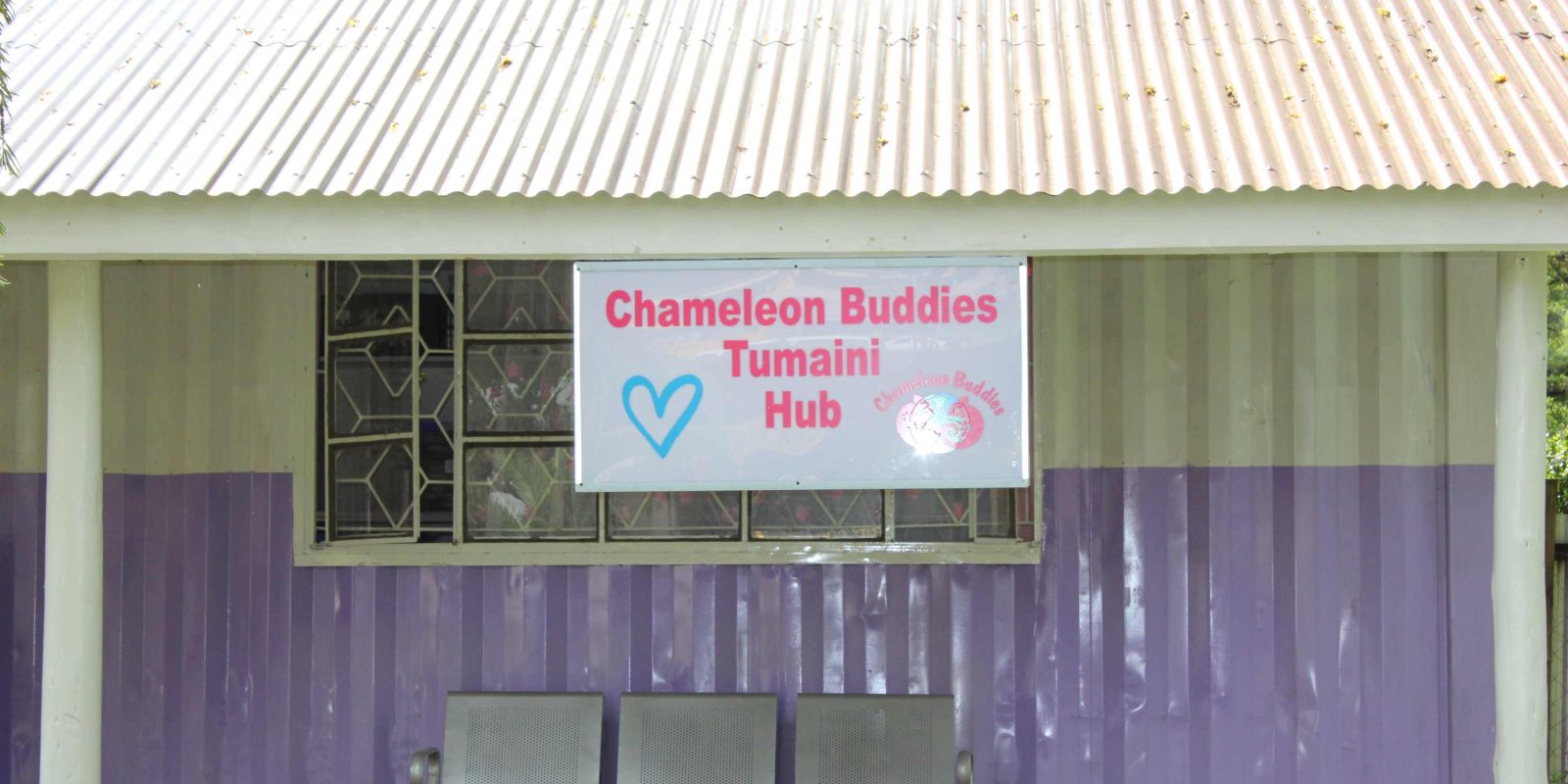 Storage shelter of stoma supplies in Africa. Building signage reads 'Chameleon Buddies' Tumaini Hub
