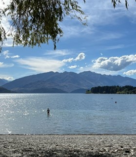 View of a lake against a backdrop of hills on a sunny day