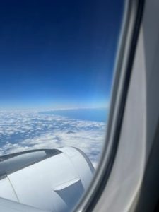 View through the aeroplane window at the clouds below