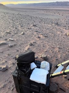 A makeshift table of stoma supplies ready for use against an empty desert backdrop.