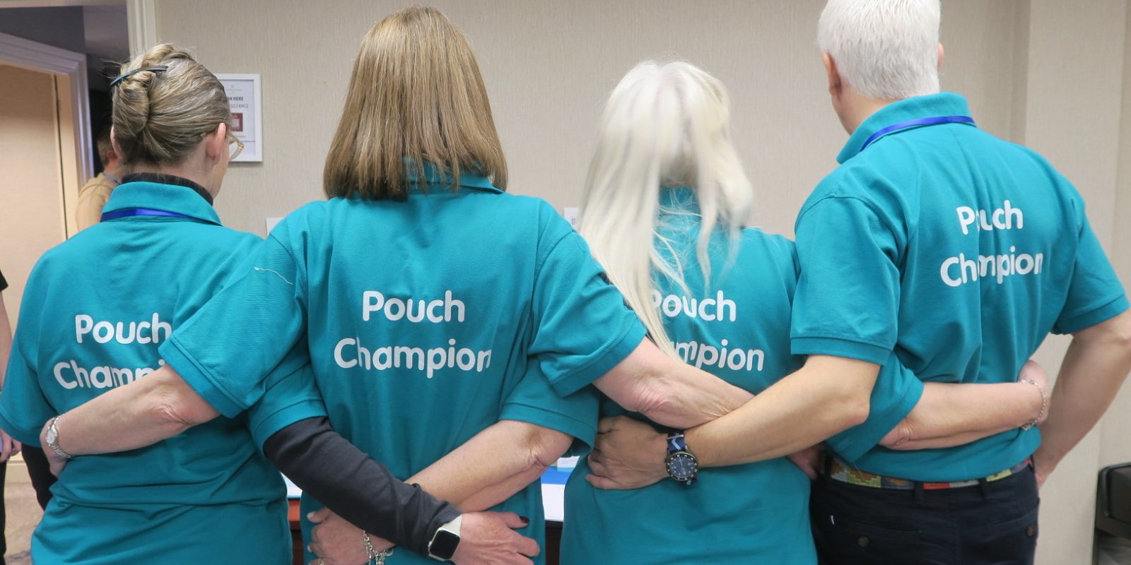 Back view of volunteers wearing Internal Pouch volunteer t-shirts